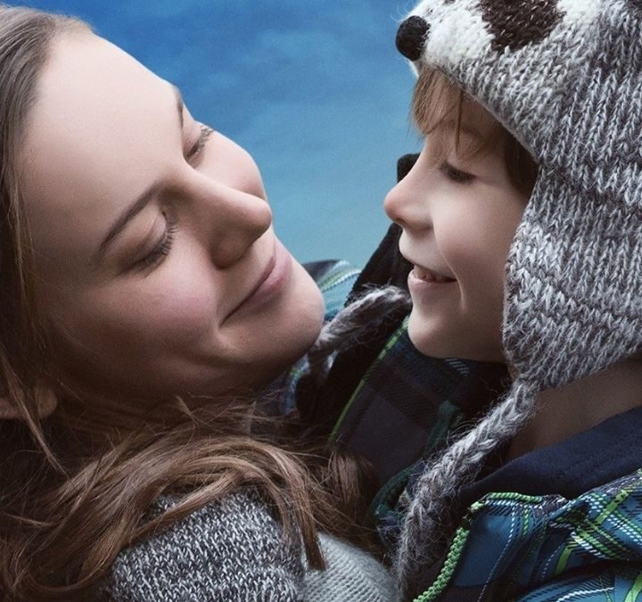 Ma and Jack smiling on the poster for Room.