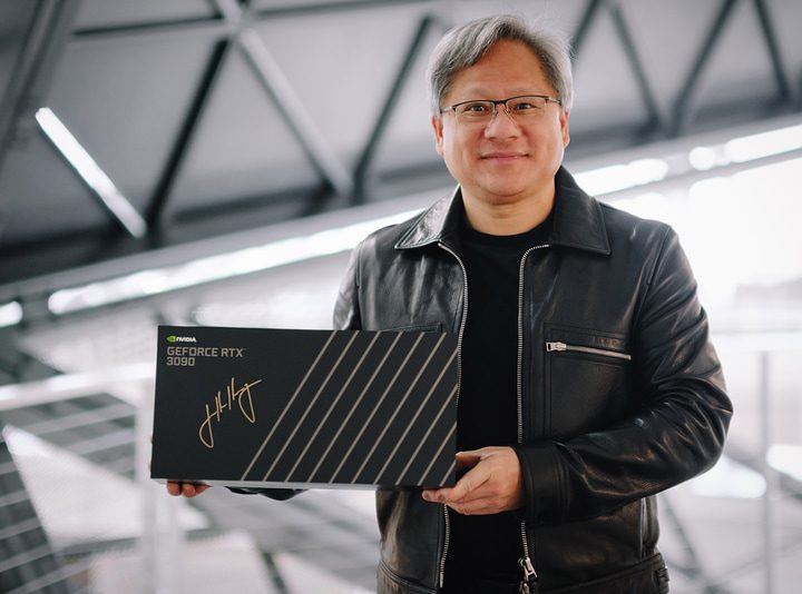 Nvidia CEO Jensen Huang holds a signed RTX 3090 graphics card box.