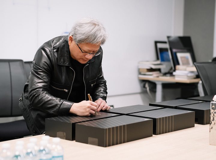 Nvidia CEO Jensen Huang signs RTX 3090 graphics card boxes.