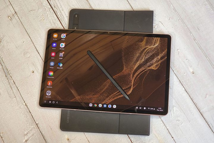 The Samsung Galaxy Tab S8+ sits on top of the book cover.