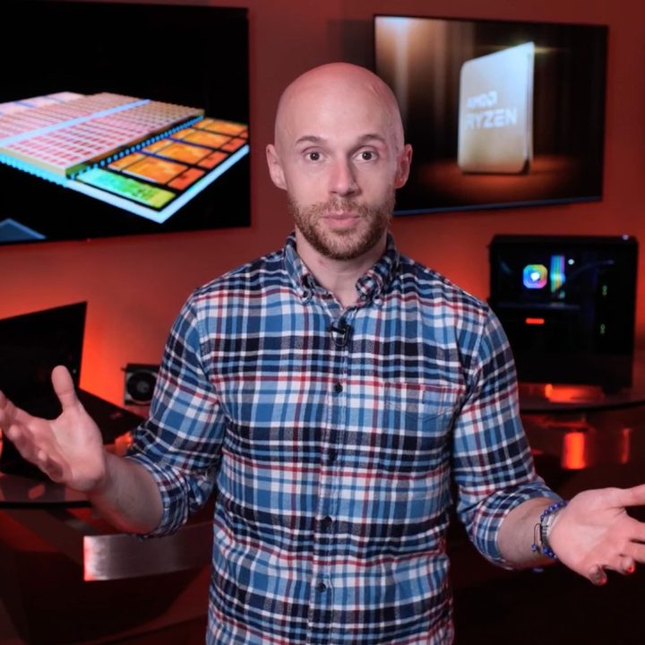 AMD representative in front of a photo of the Ryzen 7 5800X3D.