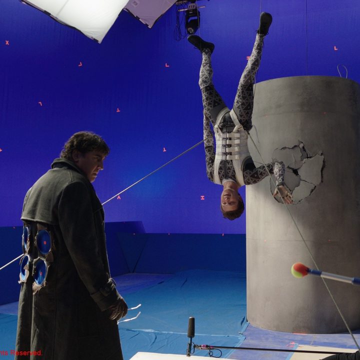 Alfred Molina and Tom Holland perform a scene against a blue screen while filming Spider-Man: No Way Home.