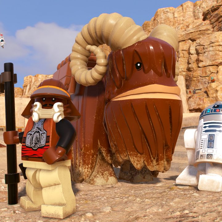 Lando and R2D2 stand by a Bantha in Lego Star Wars: The Skywalker Saga.