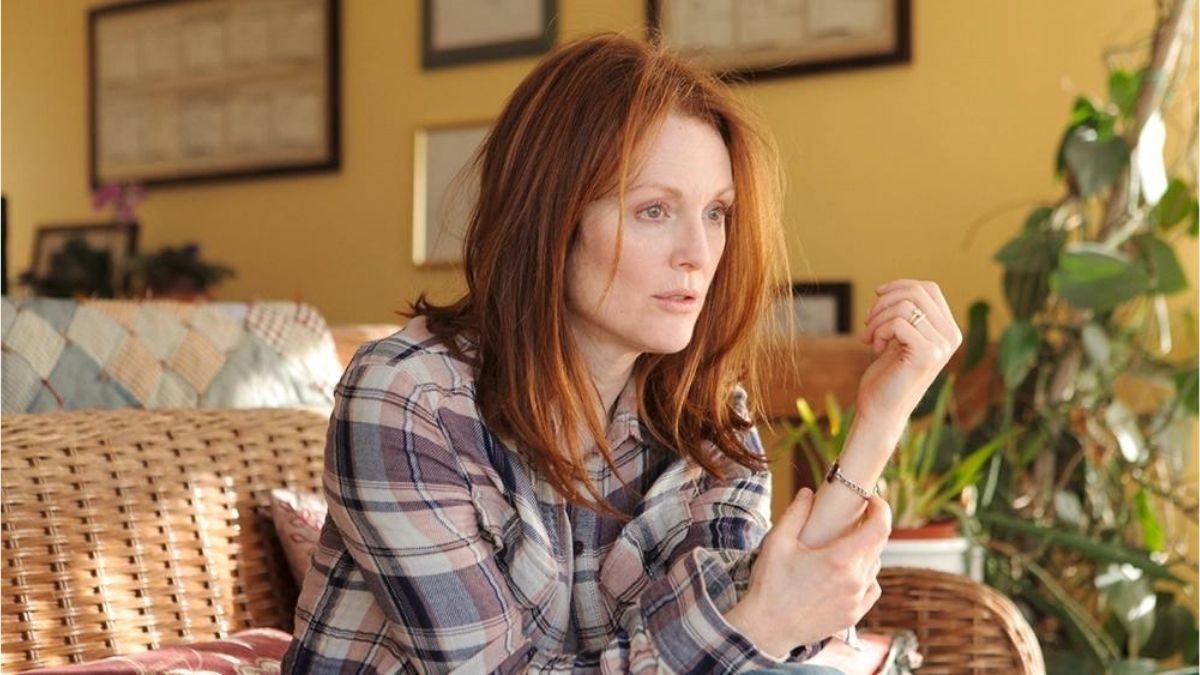 Alice looking confused while sitting on a wicker couch in Still Alice.