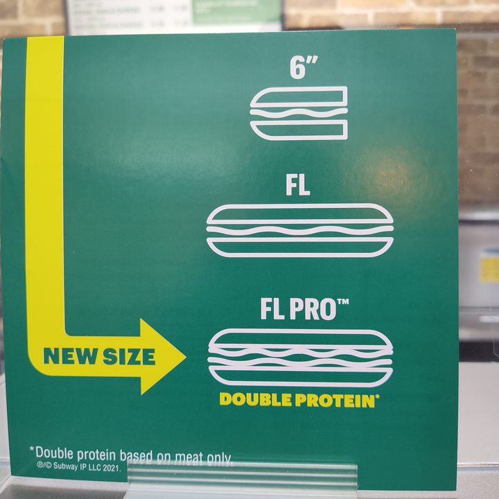 A sign shows that a Subway double-meat footlong sandwiched are called "pro".