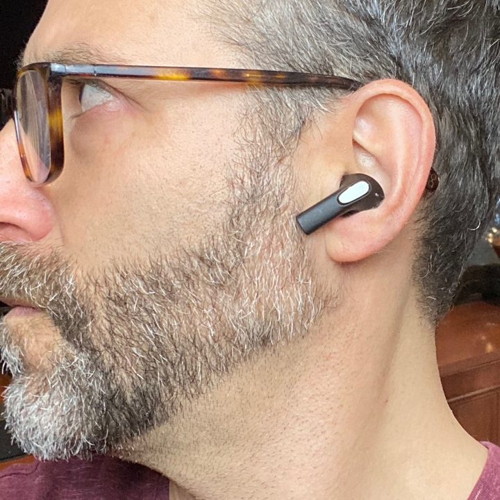 Man wearing Sudio E2 wireless earbuds.