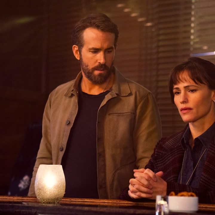 Ryan Reynolds looks at Jennifer Garner at a bar in a scene from The Adam Project.