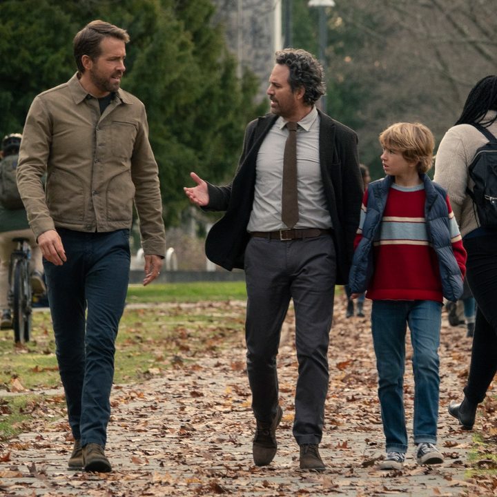 Ryan Reynolds, Mark Ruffalo, and Walker Scobell walk together and talk in a scene from The Adam Project.