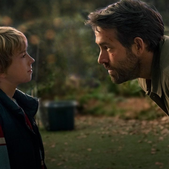 Walker Scobell and Ryan Reynolds look at each other in a scene from The Adam Project.