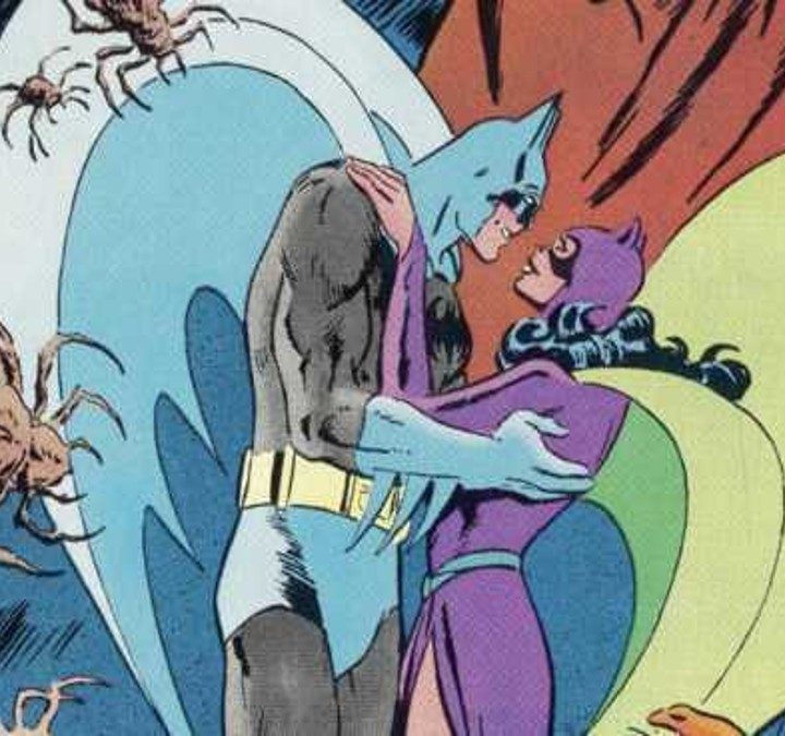 Batman and Catwoman embrace in a DC comic book.
