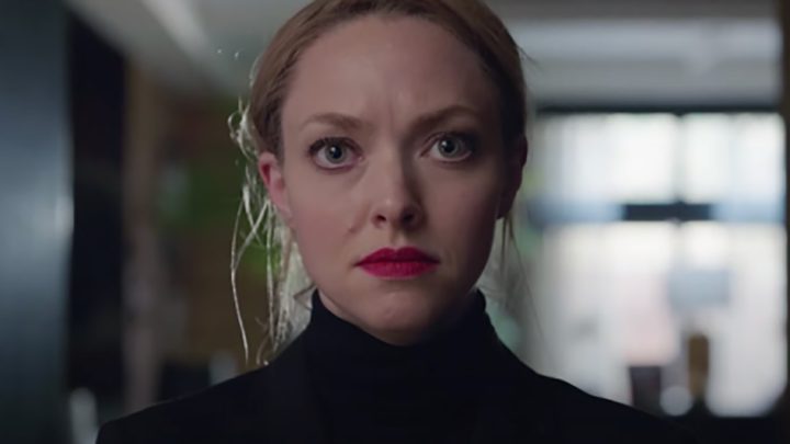 Elizabeth Holmes staring into the camera, wearing a black turtleneck as Elizabeth Holmes in The Dropout.