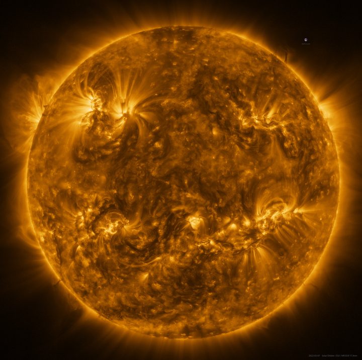The Sun as seen by Solar Orbiter in extreme ultraviolet light from a distance of roughly 75 million kilometers. An image of Earth is also included for scale, at the 2 o’clock position.