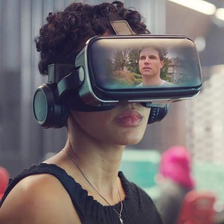 Nora wears VR glasses showing Nathan on the screen in a scene from Upload on Amazon Prime.