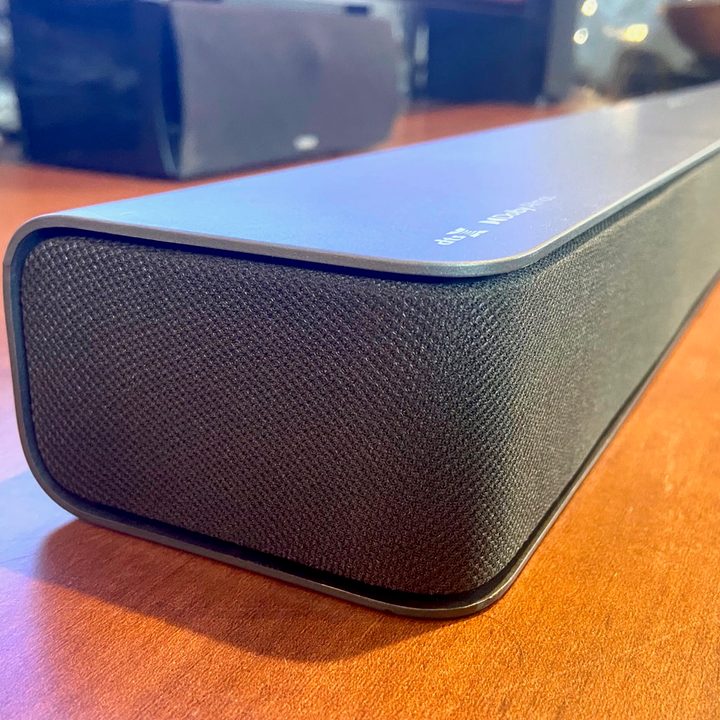 A side view of the Vizio M-Series 2.1 soundbar sitting on a table.