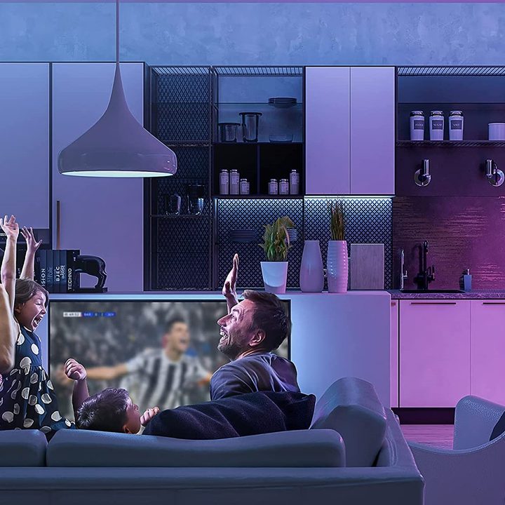 Family enjoying a soccer game on TV with a Vont Smart LED Light Strip installed in their home.
