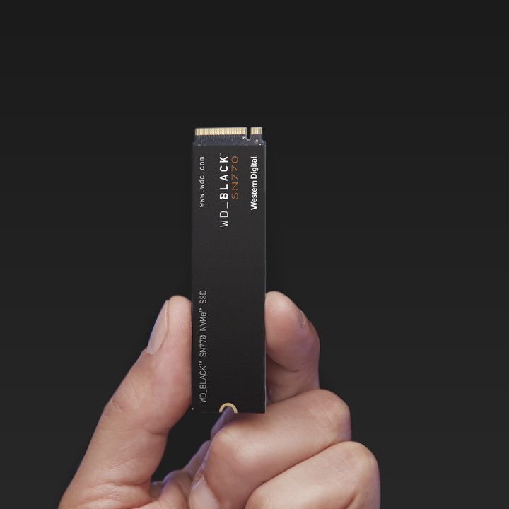 A person holding the WD Black SN770 gaming SSD.