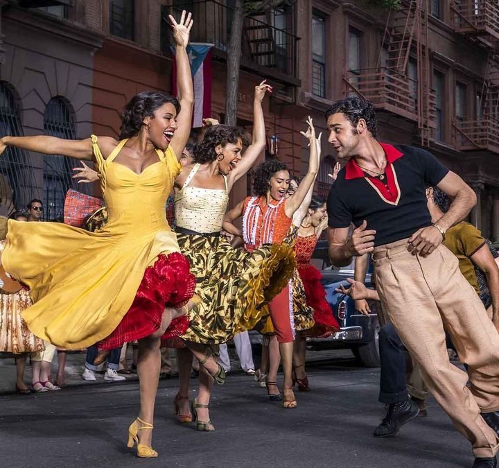 Men and women dance on a street in West Side Story.
