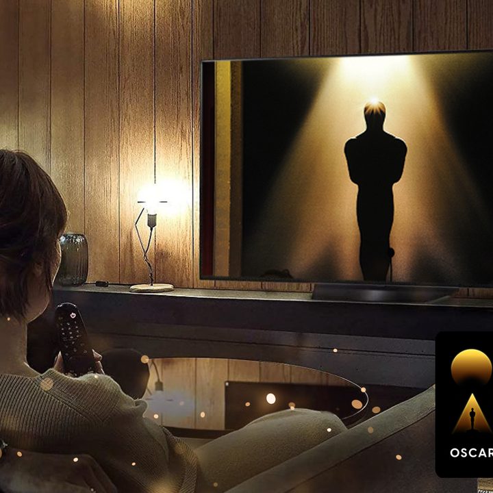 An "Oscars Week" badge overlaid on an image of an a woman watching the Oscars.