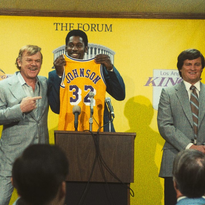 John C Reilly, from left, Quincy Isaiah, and Jason Clarke stand on a podium in a scene from Winning Time.