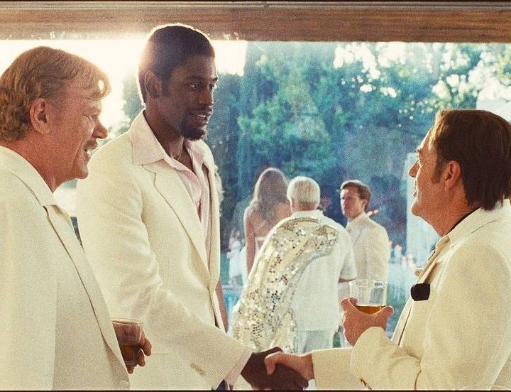 John C. Reilly and Quincy Isaiah attend a party in a scene from Winning Time.