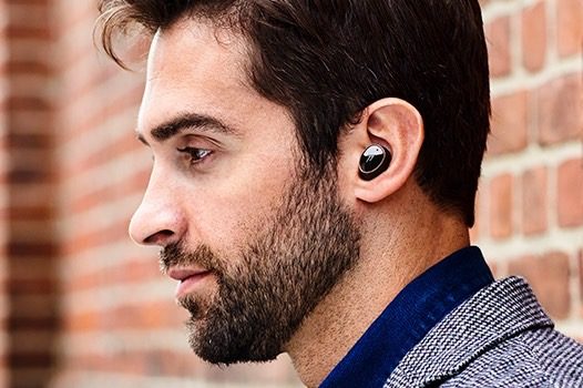 Man wearing 1More Evo wireless earbuds.
