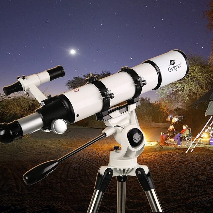 A Gskyer 600x90mm AZ Astronomical Refractor Telescope aimed at the night sky near a family campsite.