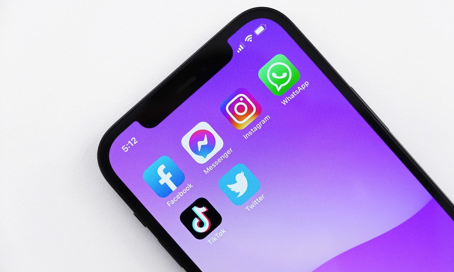 A series of social media app icons on a colorful smartphone screen.