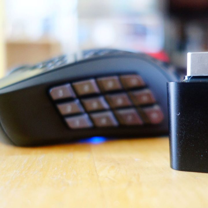 The Aerox 9 Wireless sits next to its USB-C dongle.