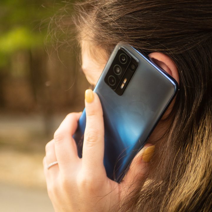 A woman holding a Blu F91 5G for a phone call