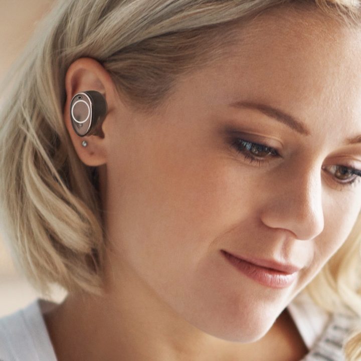 Woman wearing Creative Outlier Pro ANC earbuds.
