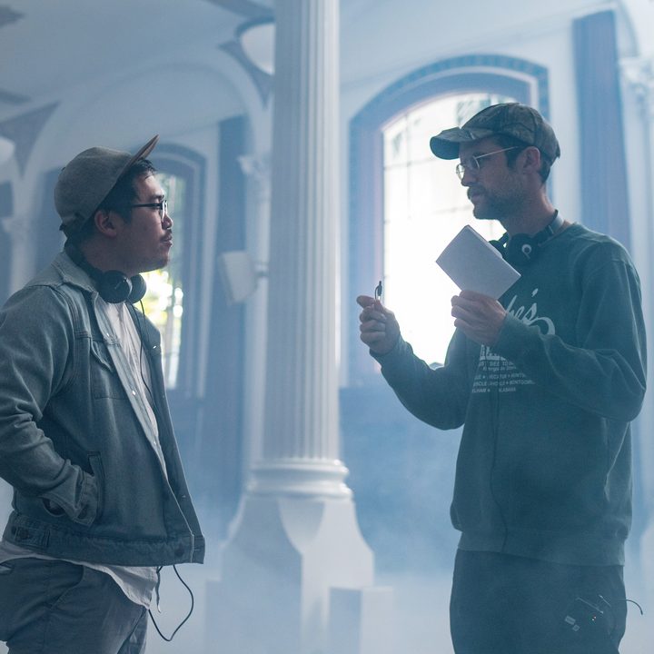 Daniel Kwan and Daniel Scheinert stand together on the temple set of Everything Everything Everywhere All At Once.