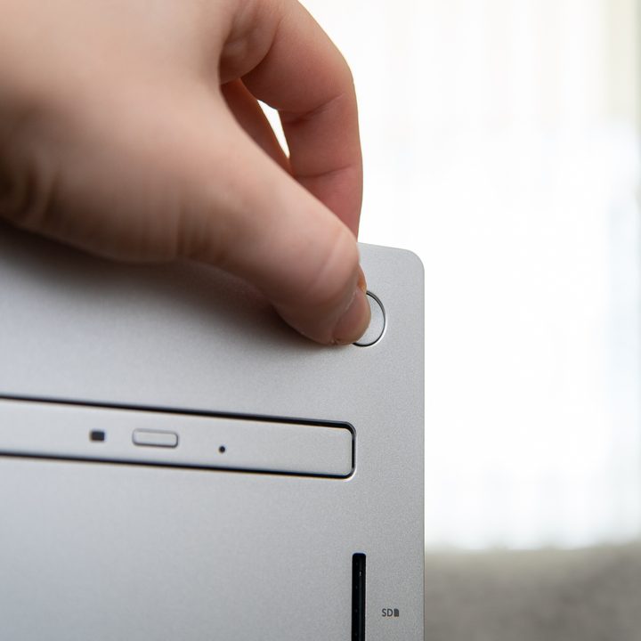 Someone pressing the power button the Dell XPS Desktop.