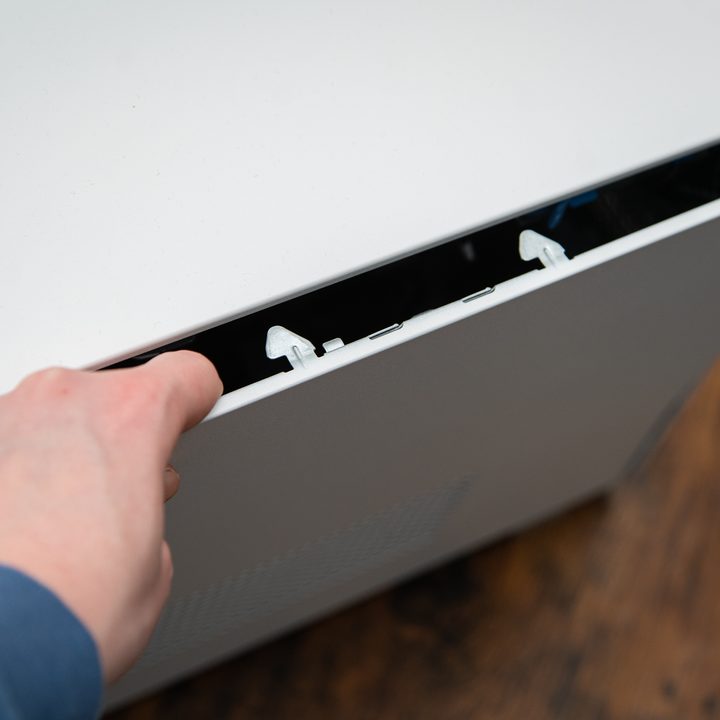 Someone opening the side panel on the Dell XPS Desktop.