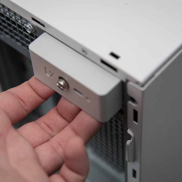 A hand unlatching the side panel on the Dell XPS Desktop.