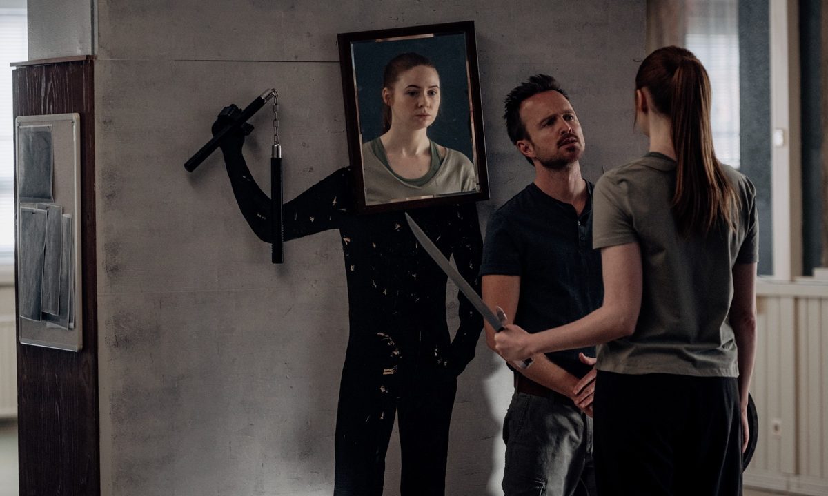 Aaron Paul and Karen Gillan discuss combat techniques in a scene from Dual.