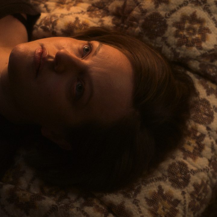 Elisabeth Moss lies on a bed in Shining Girls.