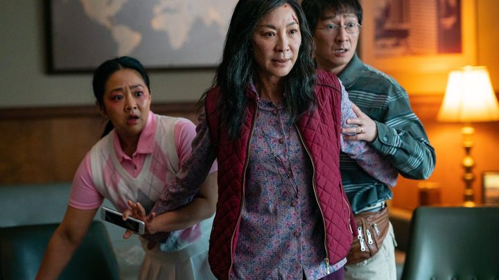 Michelle Yeoh stands in front of her character's husband and daughter in a scene from Everything Everywhere All At Once.