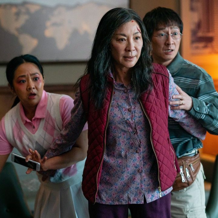 Michelle Yeoh stands in front of her character's husband and daughter in a scene from Everything Everywhere All At Once.