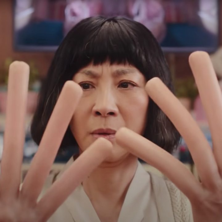 Michelle Yeoh looks at her hot dog fingers in "Everything Everywhere All at Once."