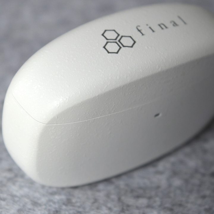 Close-up of the Final Audio ZE3000 charging case, showing the "Shibo" finish texture.