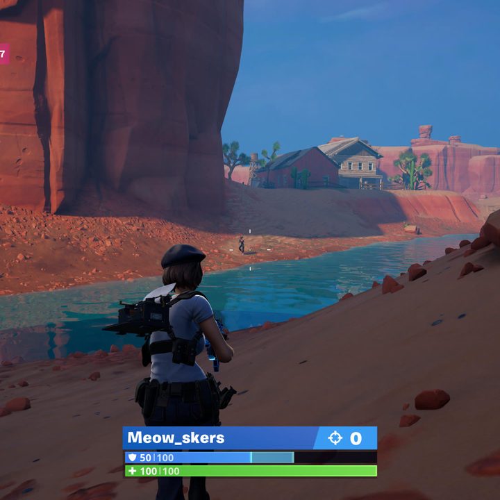 A player shoots opponent with assault rifle in Fortnite.