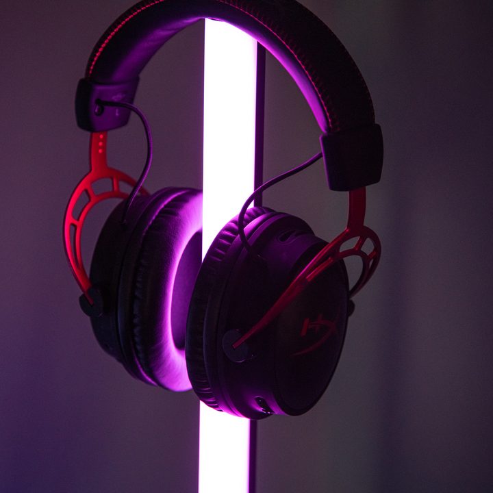 The Cloud Alpha Wireless headset resting on a purple light.