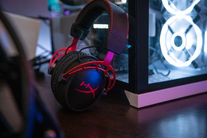 HyperX Cloud Alpha Wireless headset leaning against a gaming PC.