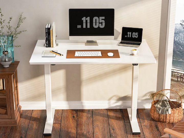 The Inbox Zero Dojtcho Height Adjustable Standing Desk with an all-in-one computer and laptop on top.