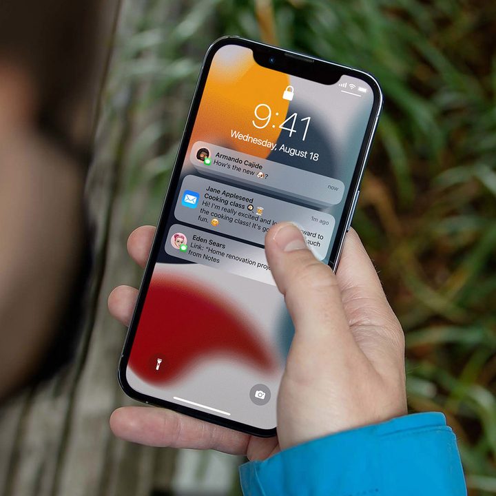 Man looking at notifications on his iPhone 12.