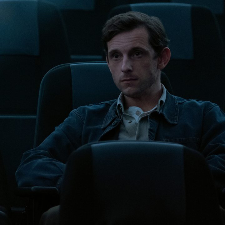 Jamie Bell sits alone in an auditorium in Shining Girls.