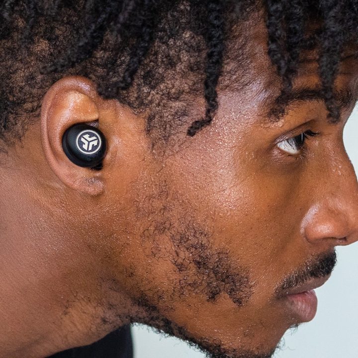 Man wearing JLab JBuds Air Pro.
