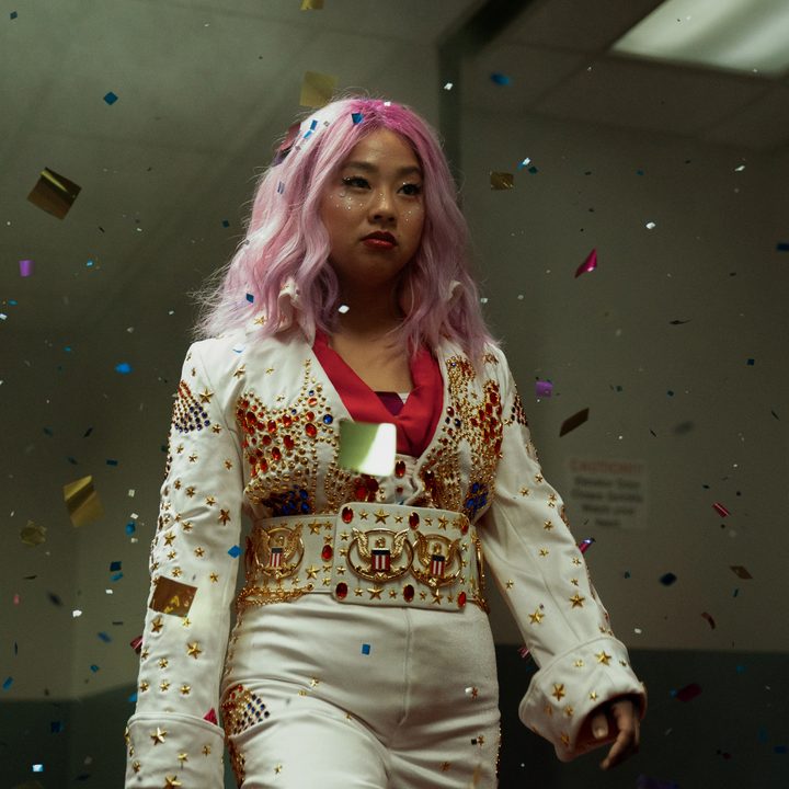Jobu Tupaki wears an Elvis costume while walking down a hallway in Everything Everywhere All At Once.