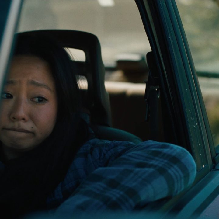 Joy looks out her car window in Everything Everywhere All At Once.