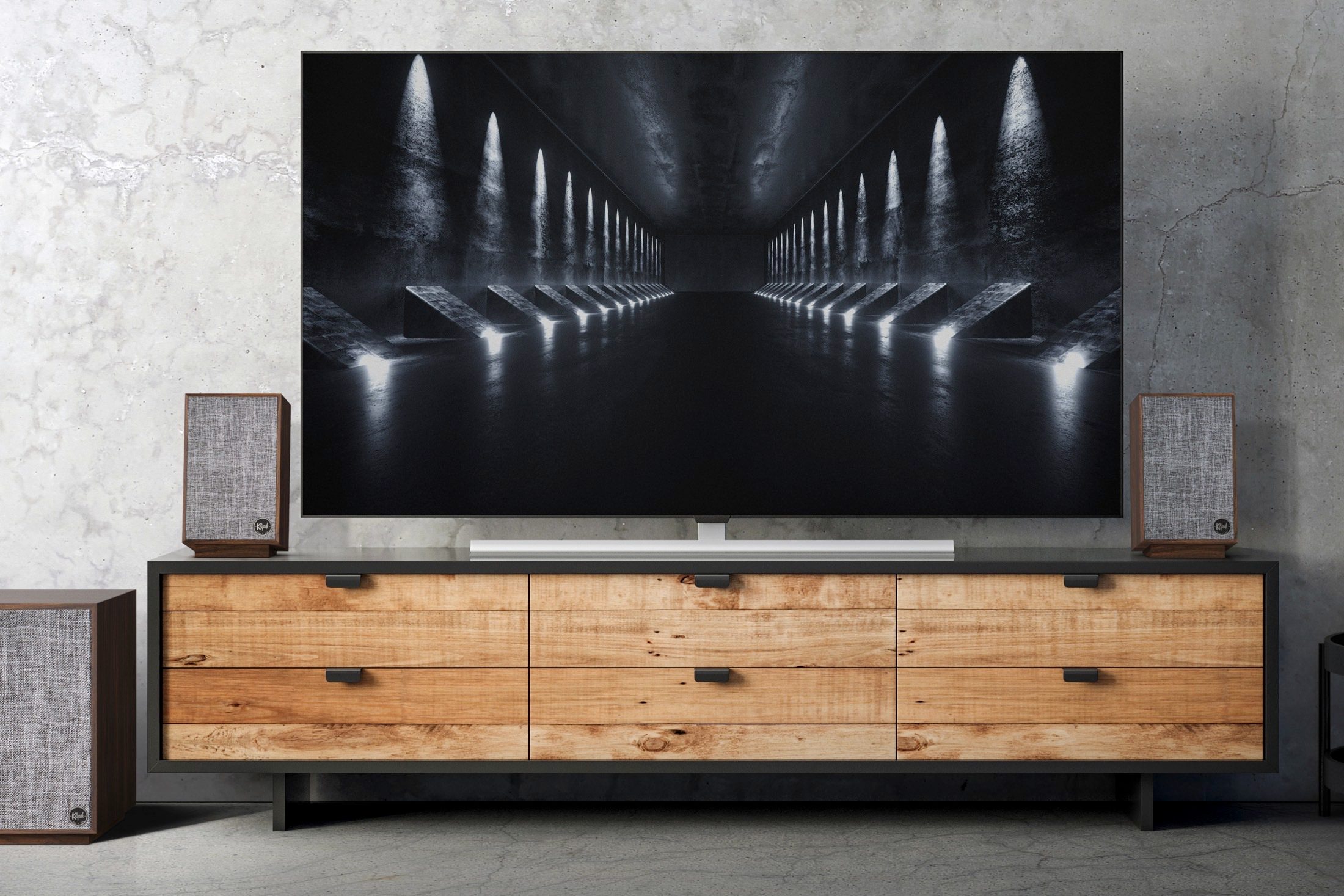 Klipsch ProMedia 2.1 speaker system seen next to a flat-screen TV.